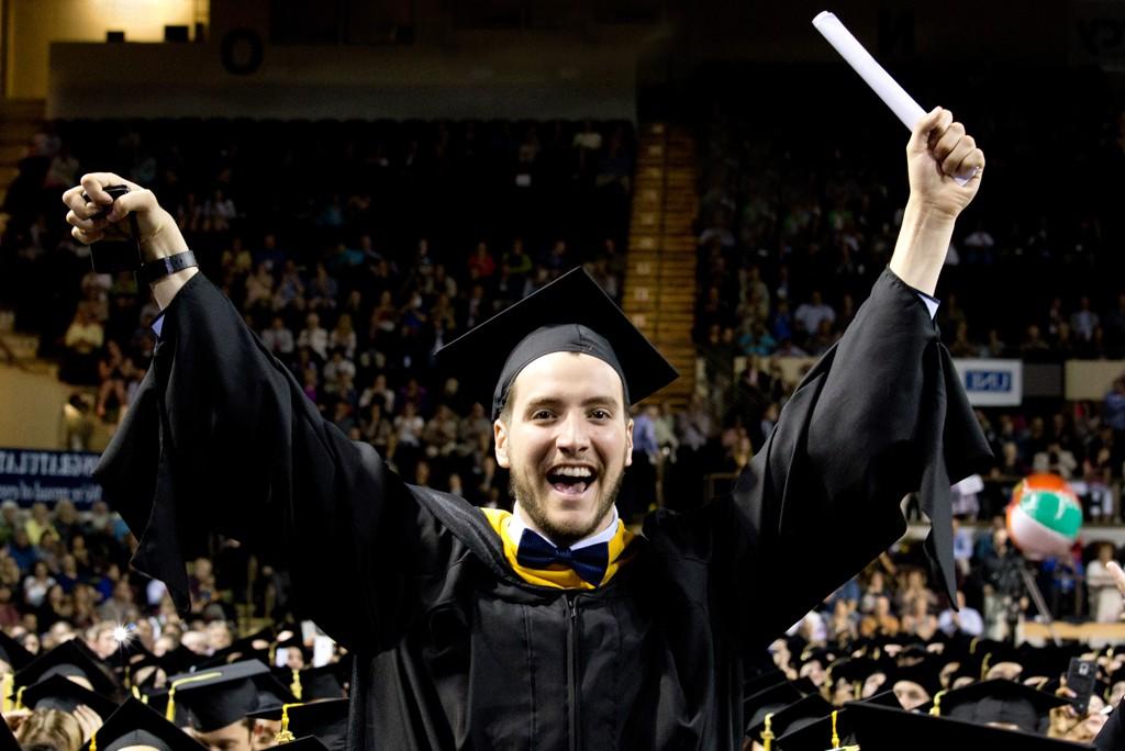 Graduating student holding diploma